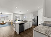 Thumbnail 4 of 35 - A modern kitchen with granite countertops and stainless steel appliances.