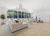 Thumbnail 22 of 35 - Savannah, GA Apartments – The Palms at Chatham– a clubhouse with a large window and a view of a pool