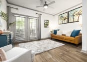 Thumbnail 7 of 35 - Savannah, GA Apartments – The Palms at Chatham– a living room with a ceiling fan and hardwood floors