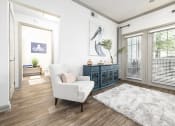 Thumbnail 8 of 35 - Pet-Friendly Apartments in Savannah, GA – The Palms at Chatham – a living room with white walls and wood flooring