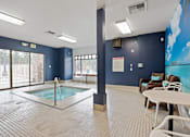 Thumbnail 37 of 47 - A room with a pool table and a hot tub.