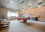 Thumbnail 41 of 47 - A room with a pool table and a couch.