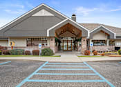 Thumbnail 46 of 47 - A building with a parking lot in front of it.
