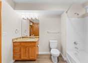 Thumbnail 16 of 47 - A bathroom with a sink, toilet, and bathtub.