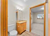 Thumbnail 17 of 47 - A bathroom with a toilet, sink, and mirror.