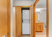 Thumbnail 18 of 47 - A kitchen with a white fridge and wooden cabinets.