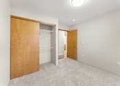 Thumbnail 14 of 47 - A room with a white wall and a brown door.