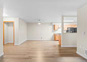 Thumbnail 7 of 47 - A room with wooden floors and white walls.