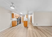 Thumbnail 5 of 47 - A kitchen with wooden floors and cabinets.