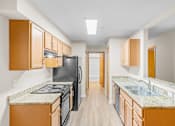 Thumbnail 1 of 47 - A kitchen with black appliances and wooden cabinets.
