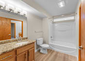 Thumbnail 15 of 47 - A bathroom with a toilet, sink, and bathtub.