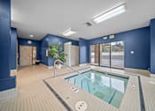Thumbnail 36 of 47 - A large indoor swimming pool with a tiled floor and walls.