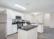 Thumbnail 3 of 15 - Pet-Friendly Rentals in Little Rock, AR – Capitol Hill – A kitchen with white cabinets and appliances.