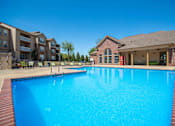 Thumbnail 9 of 15 - Apartments for Rent in Little Rock, AR 72223– Capitol Hill -   Swimming pool surrounded by club house and apartments