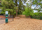 Thumbnail 28 of 34 - A dog park with a sign and a bench.