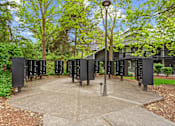 Thumbnail 30 of 34 - A series of black signs with white numbers are lined up in a park.