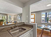 Thumbnail 2 of 34 - A kitchen with a sink and a window.