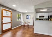 Thumbnail 4 of 34 - A kitchen area with a dining table and chairs.