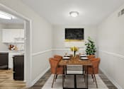 Thumbnail 7 of 25 - Apartments in Sandy Springs Georgia for Rent – Celebration at Sandy Springs - A dining room with a wooden table and chairs.