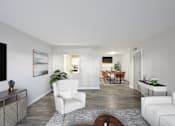 Thumbnail 8 of 25 - Pet-Friendly Apartments in Sandy Springs– Celebration at Sandy Springs – A living room with a white chair and a brown coffee table.
