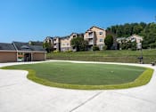 Thumbnail 21 of 31 - Apartments in Oak Ridge, TN for Rent- Centennial Village- golf putting green area