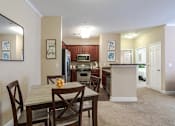 Thumbnail 7 of 31 - Pet-Friendly Apartments in Oak Ridge, TN – Centennial Village – a kitchen and dining room with a table and chairs
