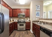 Thumbnail 1 of 31 - Apartments in Oak Ridge, TN for Rent- Centennial Village a kitchen with stainless steel appliances and wooden cabinets
