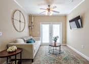 Thumbnail 8 of 31 - Apartments for Rent in Oak Ridge, TN 37830 – Centennial Village – a living room with a couch and a ceiling fan