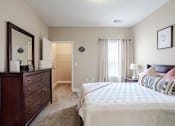 Thumbnail 10 of 31 - Apartments in Oak Ridge, TN for Rent- Centennial Village a bedroom with a bed and a dresser