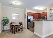 Thumbnail 6 of 31 - Apartments in Oak Ridge, TN for Rent- Centennial Village a kitchen with a table and chairs and a refrigerator