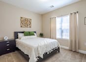 Thumbnail 12 of 31 - Apartments in Oak Ridge, TN for Rent- Centennial Village a bedroom with a bed and a window