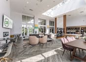 Thumbnail 22 of 25 - A modern dining area with a wooden table and chairs.