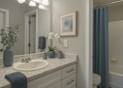 Thumbnail 7 of 13 - A bathroom with a white sink and a blue towel.