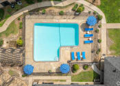 Thumbnail 3 of 28 - arial view of a swimming pool with blue umbrellas and chairs around it