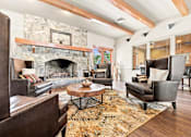 Thumbnail 36 of 47 - A living room with a stone fireplace and wooden beams.