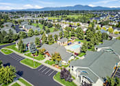 Thumbnail 44 of 47 - A bird's eye view of a residential neighborhood with houses, a pool, and a flagpole.
