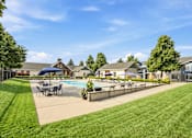 Thumbnail 27 of 47 - A sunny day at a residential area with a pool and a fence.