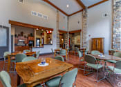 Thumbnail 7 of 13 - A dining room with a wooden table surrounded by chairs.