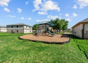 Thumbnail 17 of 19 - Affordable Apartments in Austin, TX for Rent – Huntington Meadows- a playground with a swing set