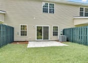 Thumbnail 28 of 28 - Omnia at Richmond Hill Townhomes in Georgia photo of spacious backyard with concrete patio