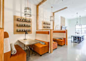 Thumbnail 12 of 17 - A modern dining area with a table and chairs.