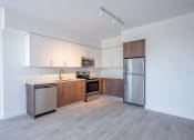 Thumbnail 3 of 20 - Countyline Apartments in Miami FL photo of kitchen with two toned cabinets and stainless steel appliances