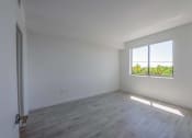 Thumbnail 12 of 20 - Countyline Apartments in Miami FL photo of bedroom with hardwood flooring and large window