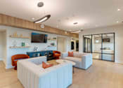 Thumbnail 15 of 22 - Community lobby with comfortable seating, contemporary lighting, and adjacent office/lounge spaces at Creekline at Fairfield, Fairfield CT.