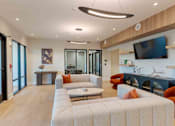 Thumbnail 16 of 22 - Community lobby with comfortable seating, stylish lighting fixtures, and a media wall at Creekline at Fairfield, Fairfield CT.