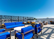 Thumbnail 18 of 22 - Community rooftop terrace with lounge furniture and skyline views at Creekline at Fairfield apartments, Fairfield CT.
