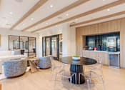 Thumbnail 14 of 22 - Resident lounge at Creekline at Fairfield apartments in Fairfield, CT featuring cozy seating, a community kitchenette, and a coffee/espresso machine station.
