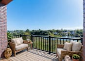 Thumbnail 4 of 22 - Private balcony at Creekline at Fairfield apartments in Fairfield, CT with scenic riverside views.