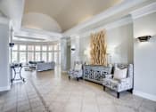 Thumbnail 6 of 20 - A living room with a grey sofa and a large window.