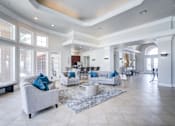 Thumbnail 2 of 20 - A spacious living room with a grey sofa and a white coffee table.